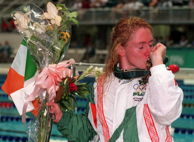 Ireland's Michelle Smith kisses her gold medal at the side of the Olympic swimming pool after winning the 100m freestyle.