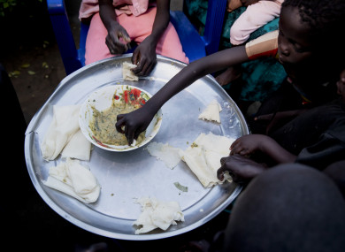 Paska Itwari Beda, the young mother of five children, shares a meal with her family at her Juba, South Sudan home. Her entire family is lucky to scrape together a single daily meal.