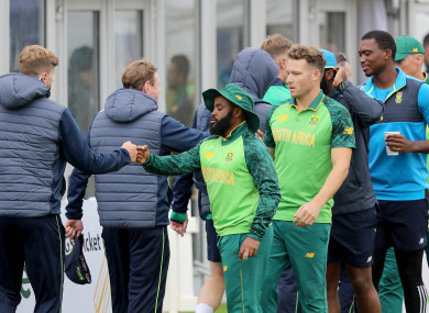 Players shake hands after the game is abandoned.