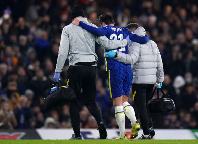 Chelsea's Ben Chilwell is helped off the pitch with an injury.