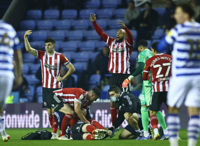 Sheffield United players call for medical help for John Fleck.