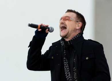 It's not clear if Bono is signing a song he likes or dislikes in this photo