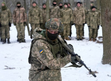 An instructor trains members of Ukraine’s Territorial Defence Forces, volunteer military units of the armed forces, in a city park in Kyiv