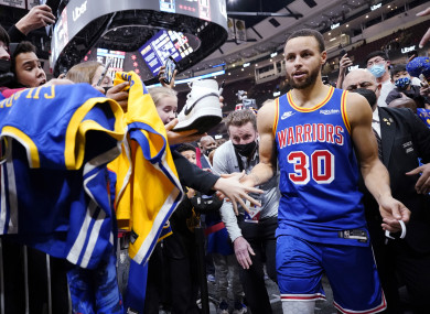 Stephen Curry celebrates with fans as he leaves the arena.