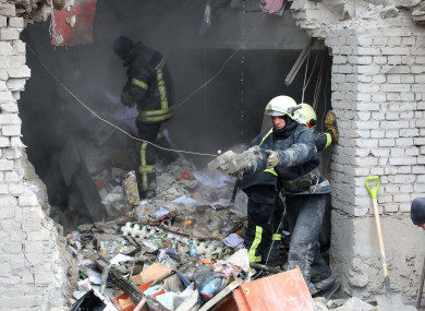 Rescuers at Kharkiv Regional State Administration building situated in Svobody Freedom Square on Tuesday in Ukraine.