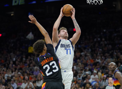 Dallas Mavericks guard Luka Doncic (77) shoots over Phoenix Suns forward Cameron Johnson.