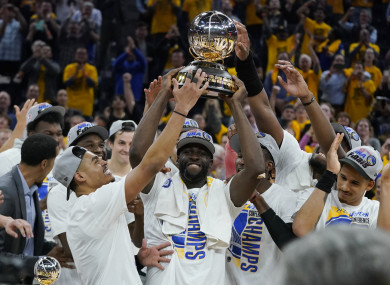 Warriors celebrate with the conference trophy.