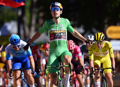Belgian Wout Van Aert of Team Jumbo-Visma celebrates as he crosses the finish line to win stage eight of the Tour de France.